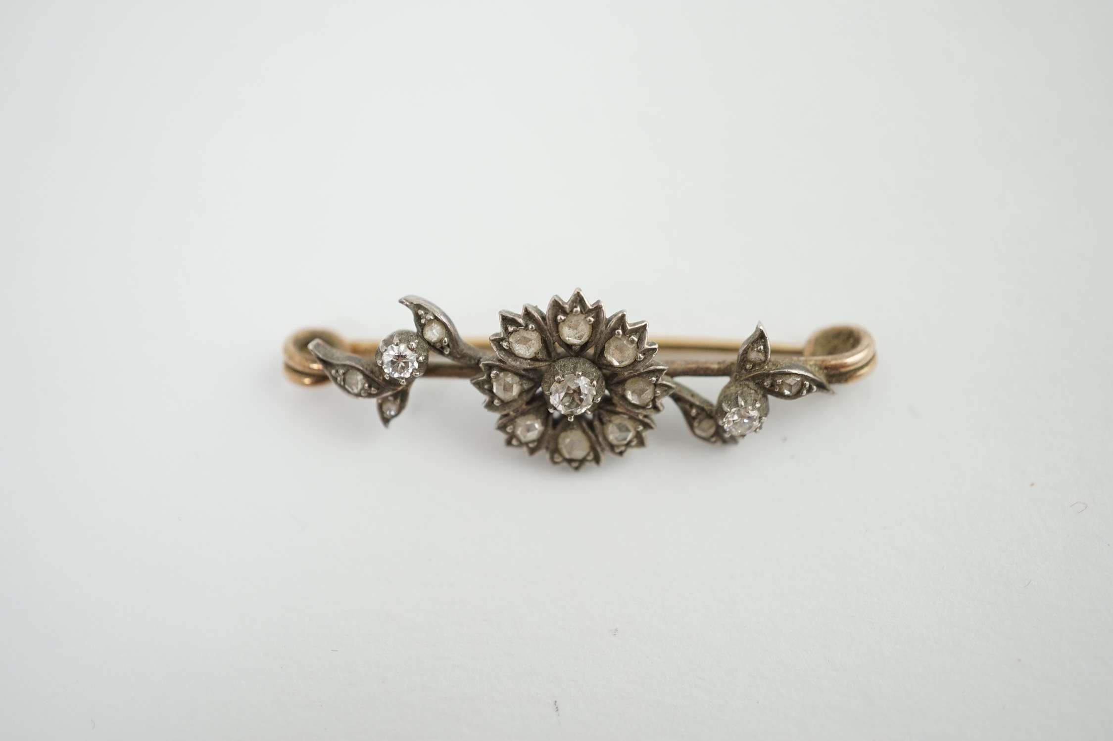 A Victorian gold, silver and diamond flower bar brooch